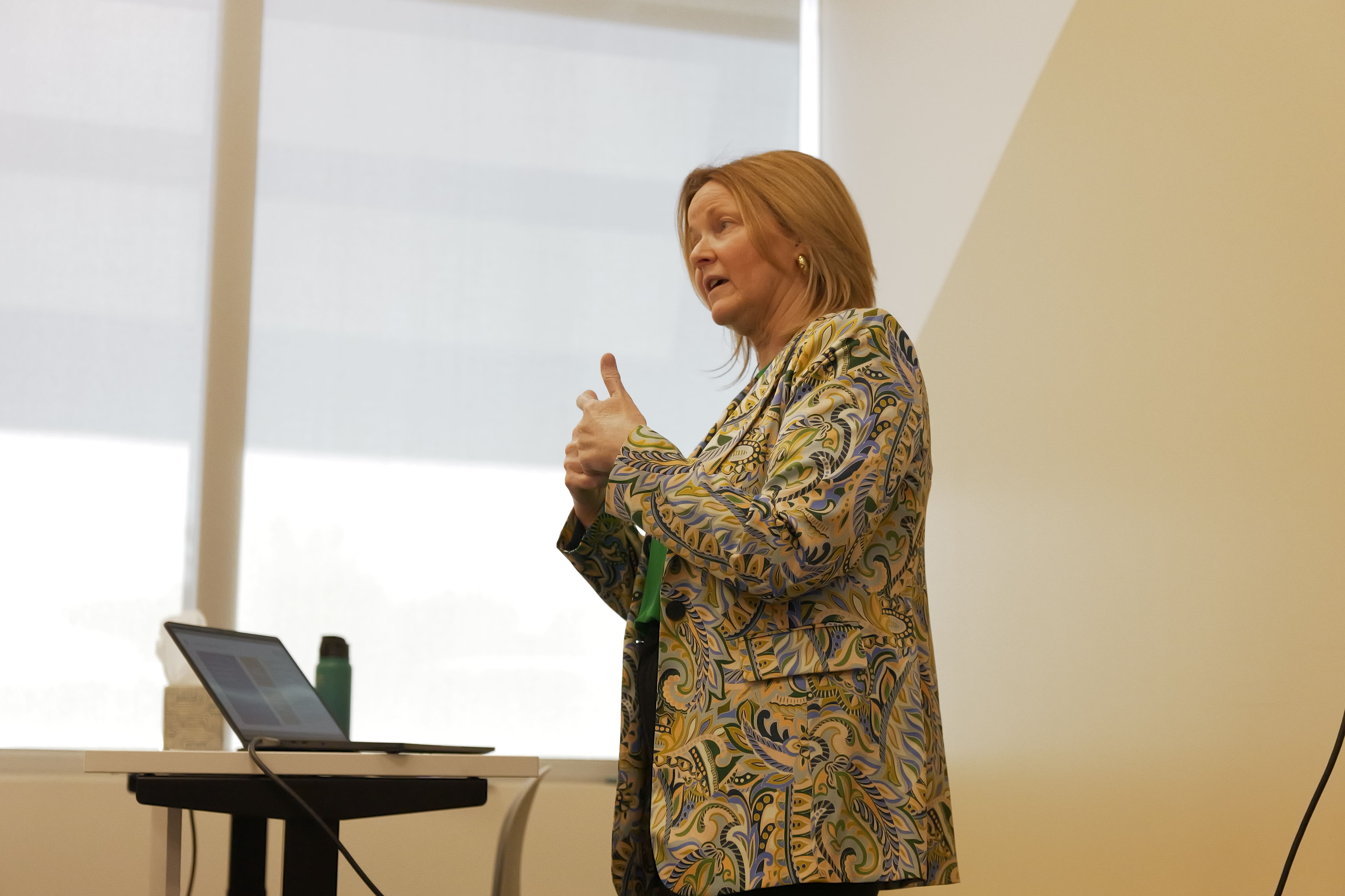 Instructor presenting beside a laptop.