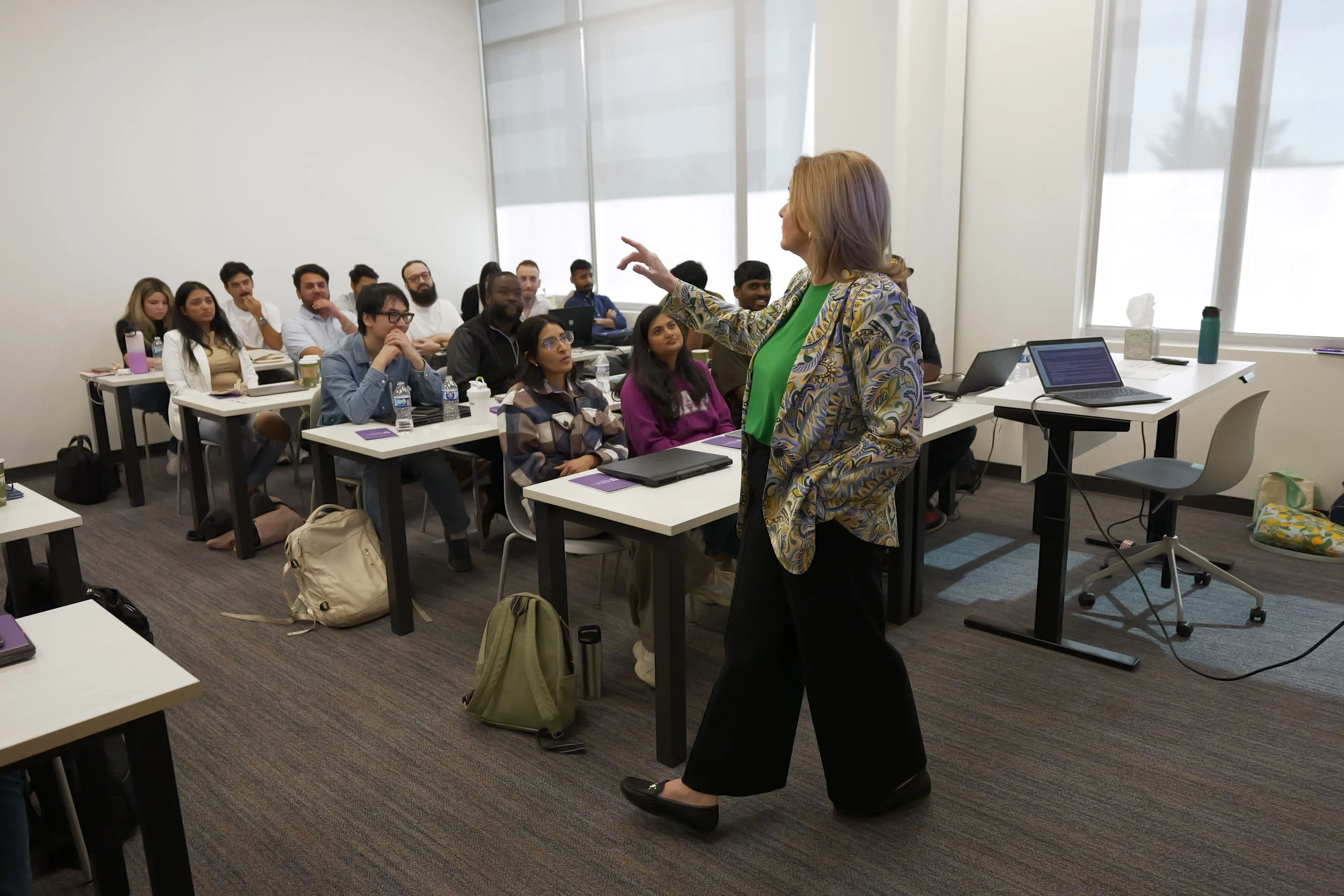 Instructor teaching a classroom of learners.
