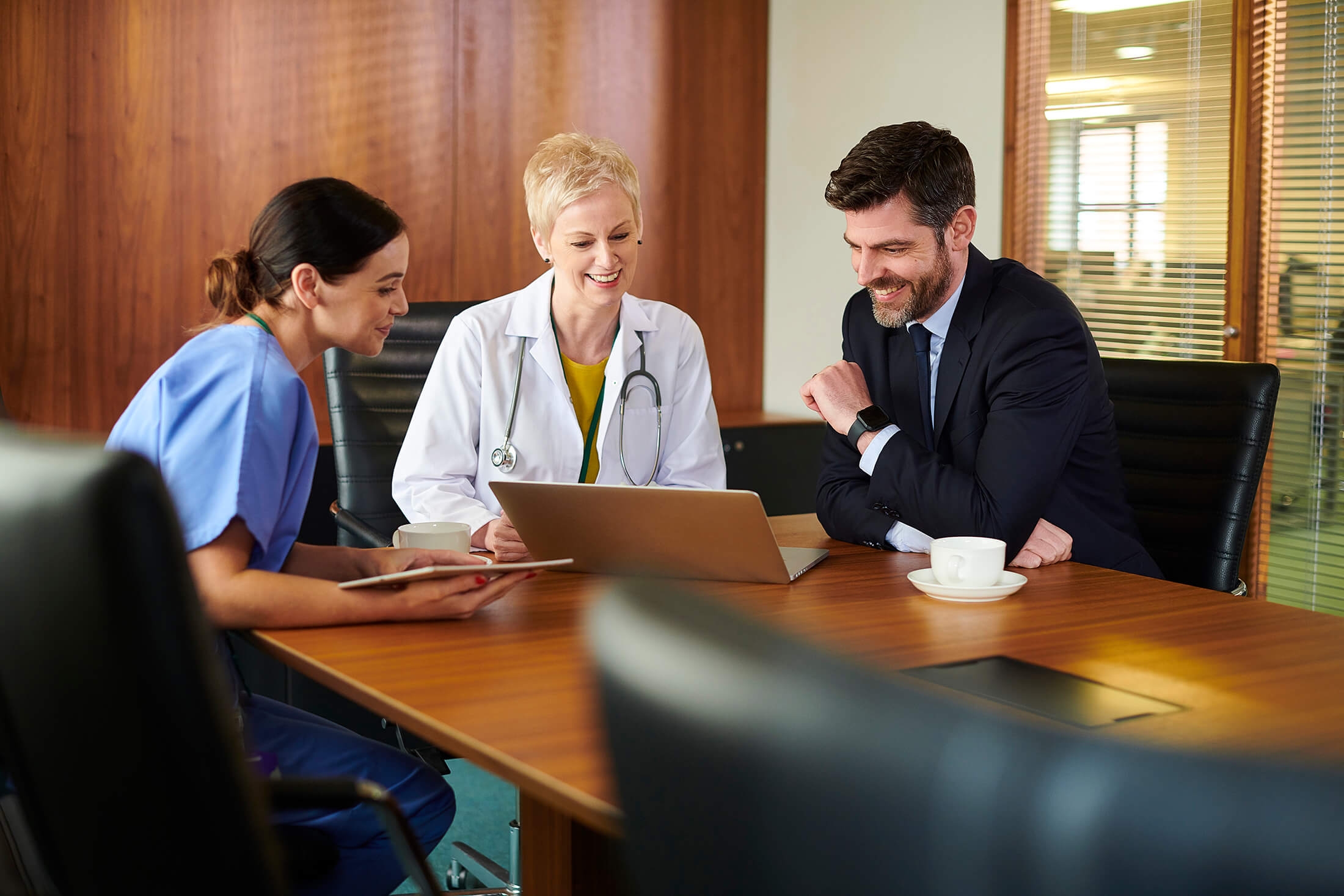 A doctor and a nurse having a chat with a business person