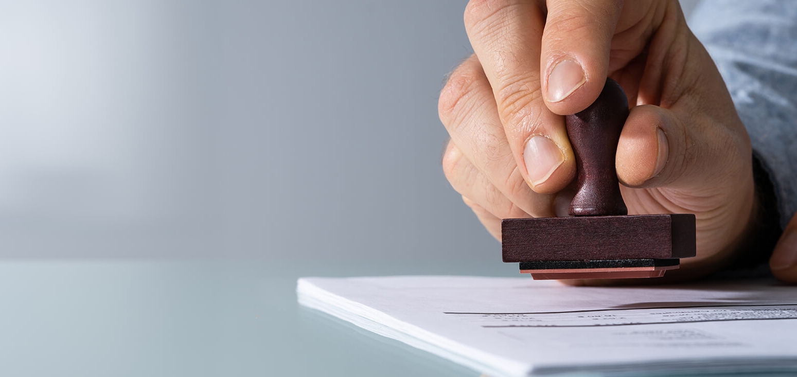 a photograph of someone ready to stamp on a papers