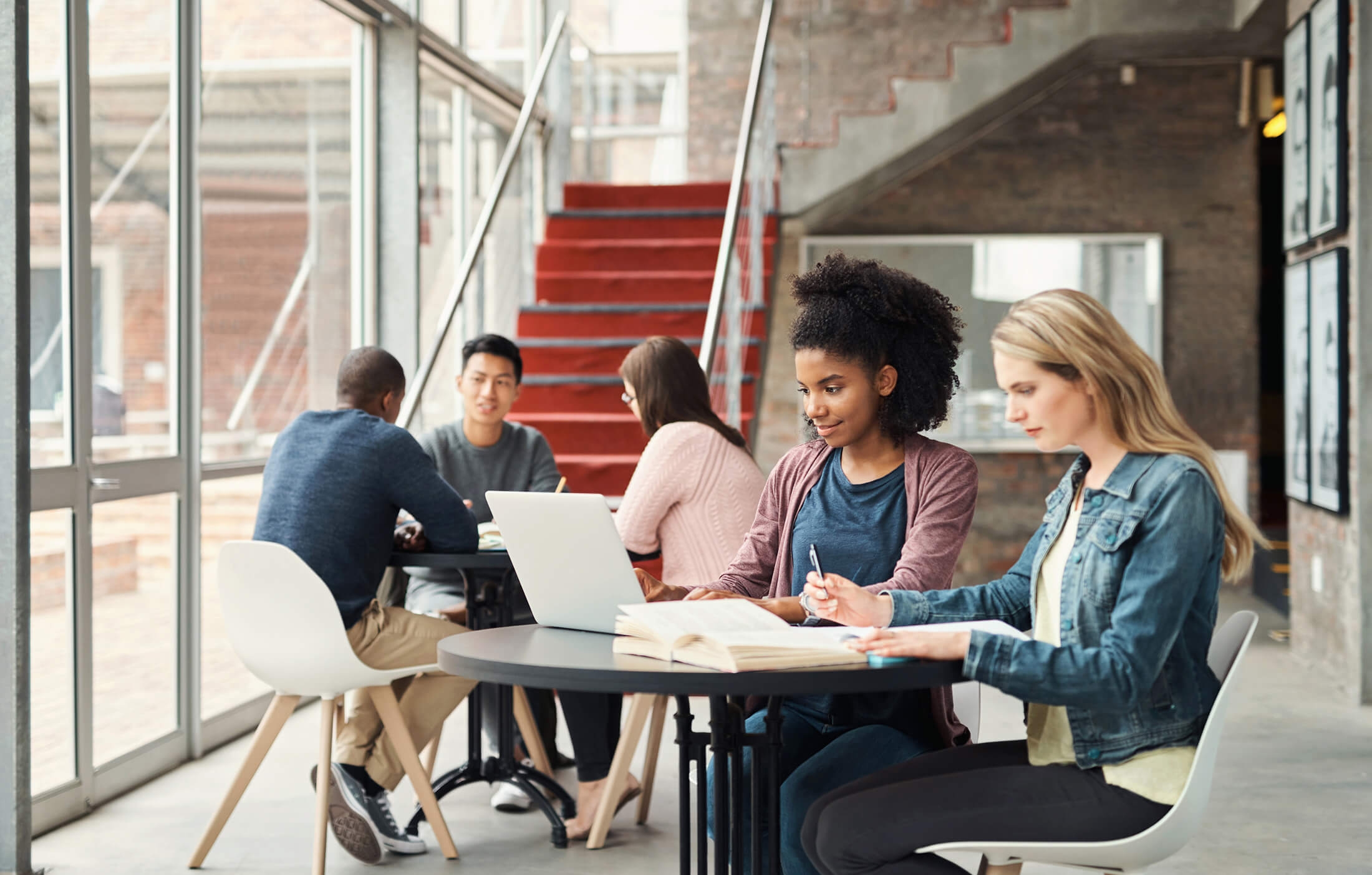 a student looking at her laptop screen in the campus