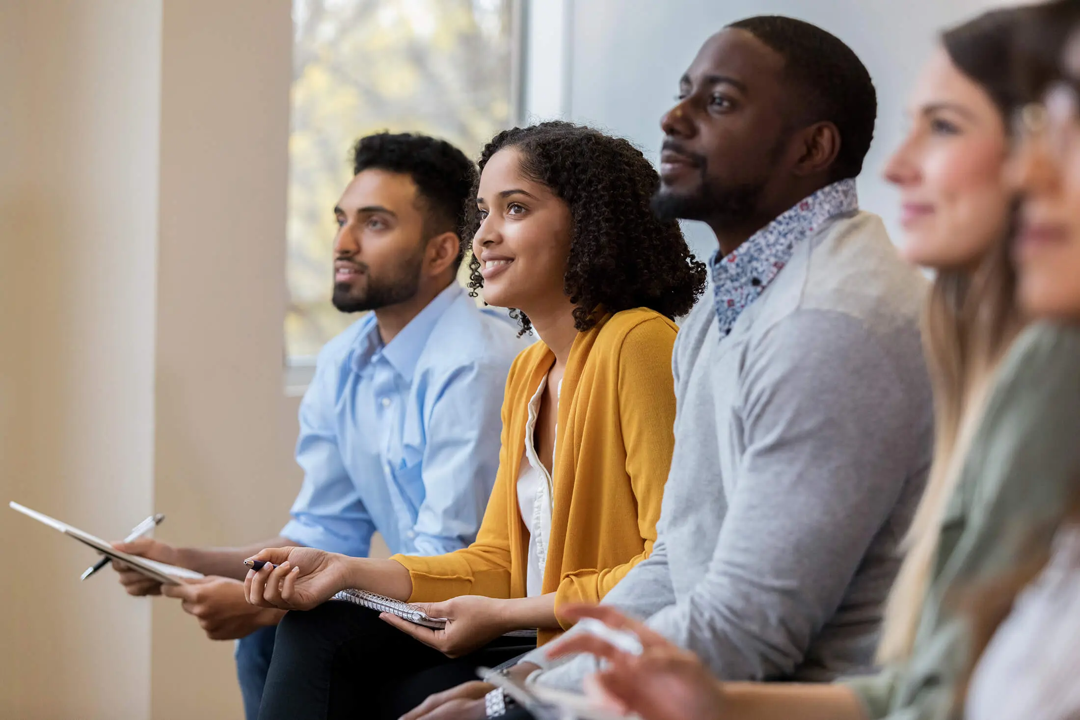 group of student sitting in a room and looking at the speaker