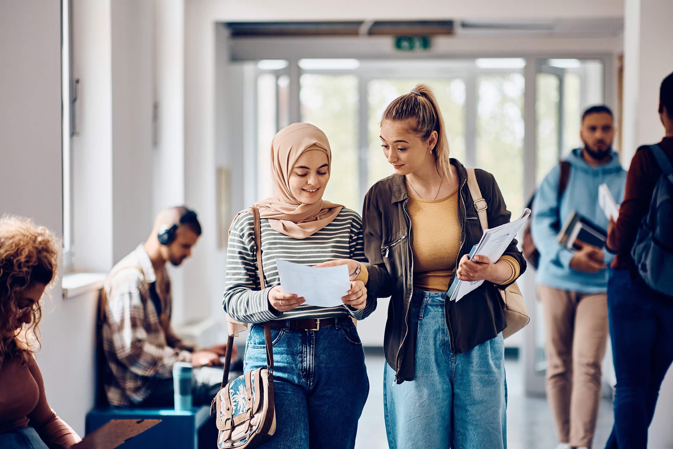 two people looking at a document and chatting