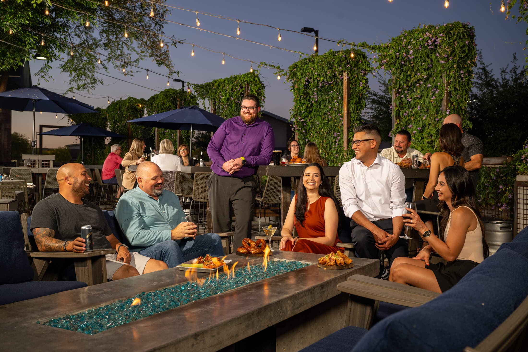 Group of people at a bar dining outside and enjoying