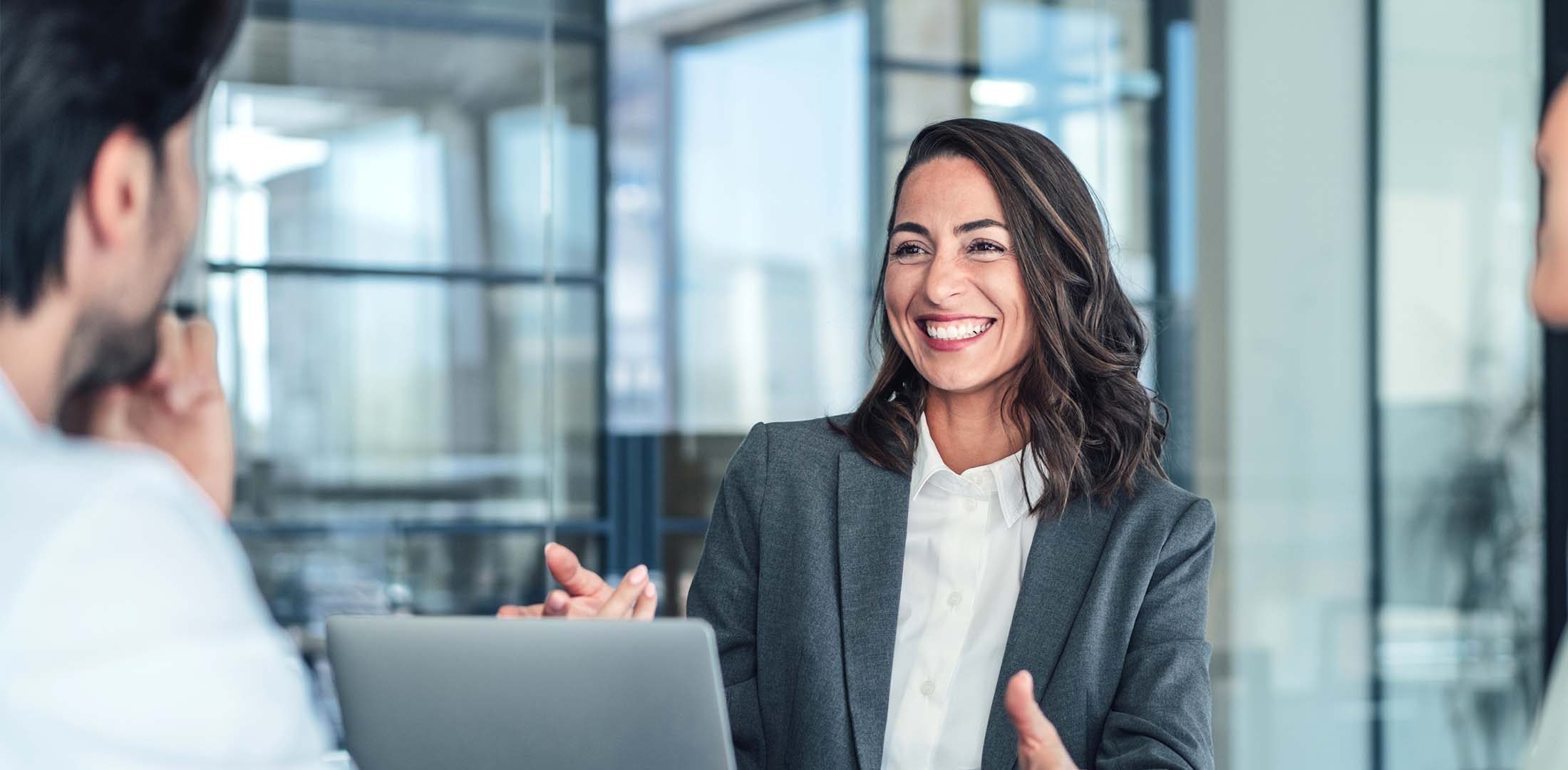 Smiling lady presenting with her laptop