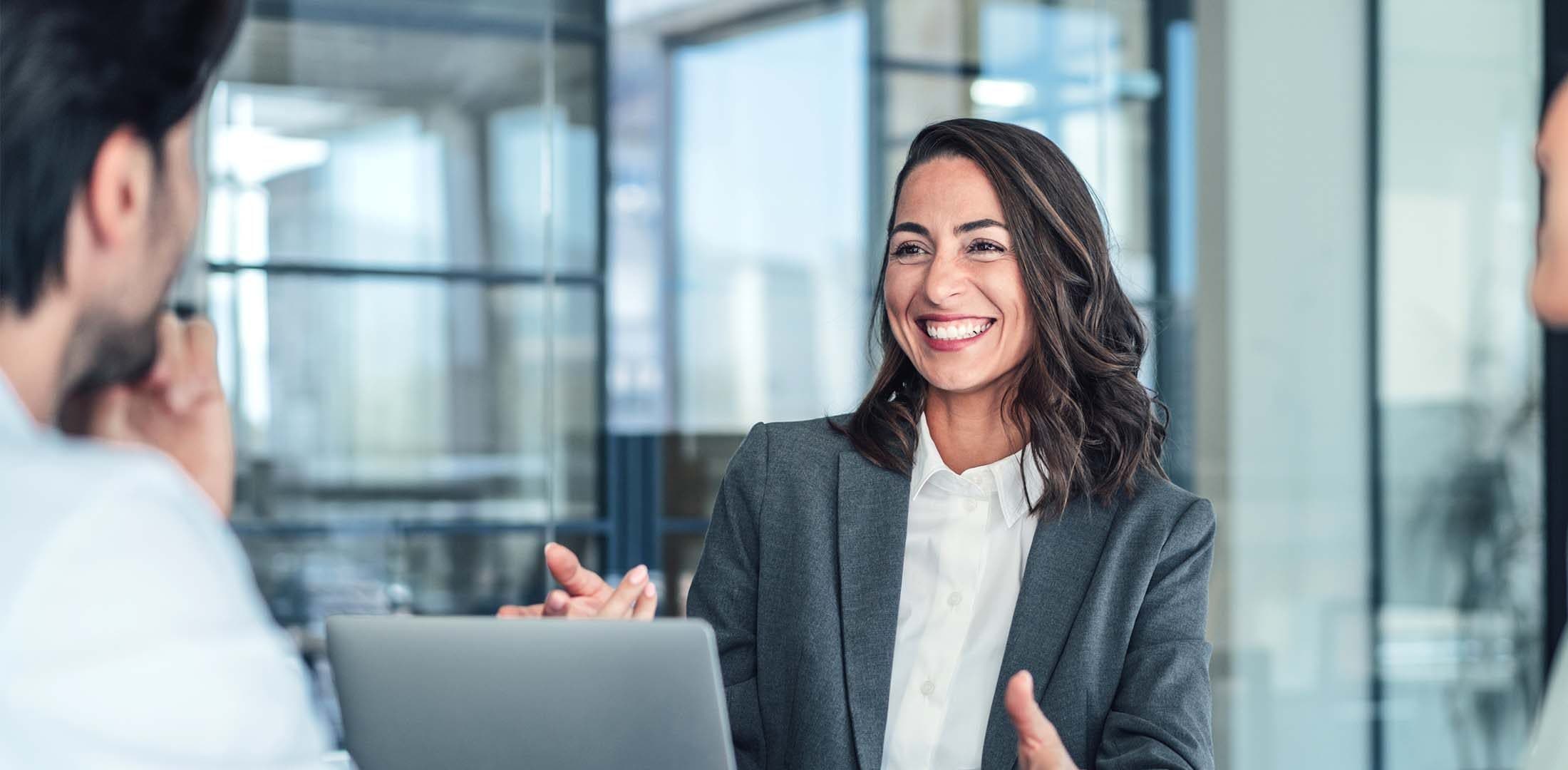 Smiling lady presenting with her laptop